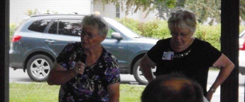 Joyce Kloncz reading the script on the three plaques, with Jan Klein’s assistance
